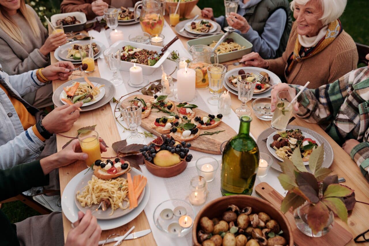 Family celebrating around a large holiday spread.