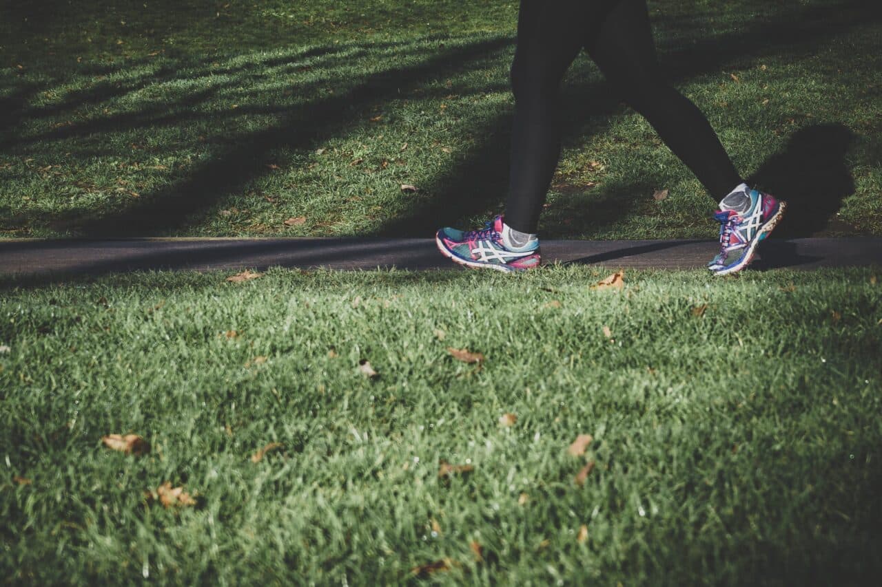 Close up of a woman running in the park.