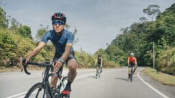 Three men cycling together