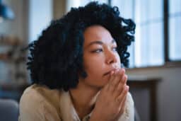 Woman looking sad looking out the window