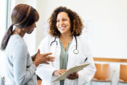 Doctor and Patient Discussing Healthcare in Clinic